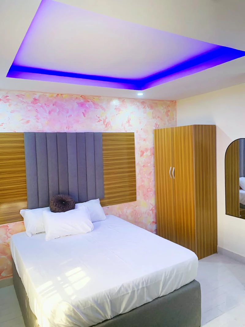 Hotel room with wardrobe and soft cove lighting