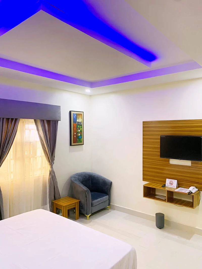 Hotel room with media shelf and wall TV