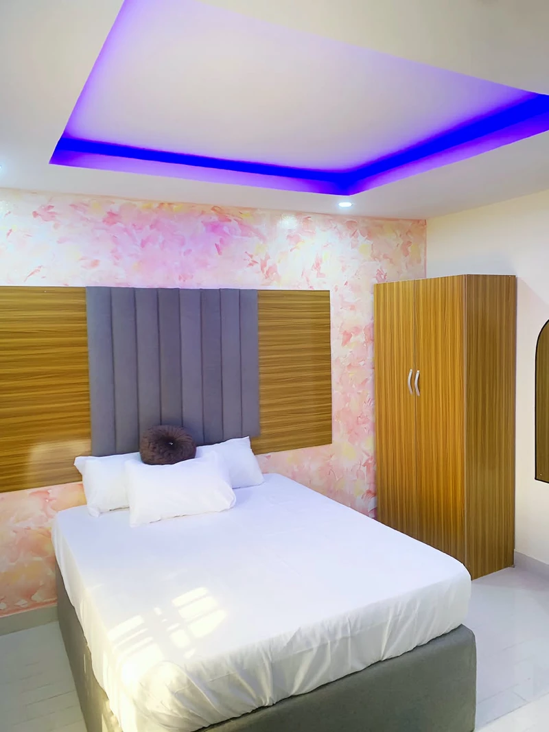 Hotel room with double bed, wardrobe and mirror