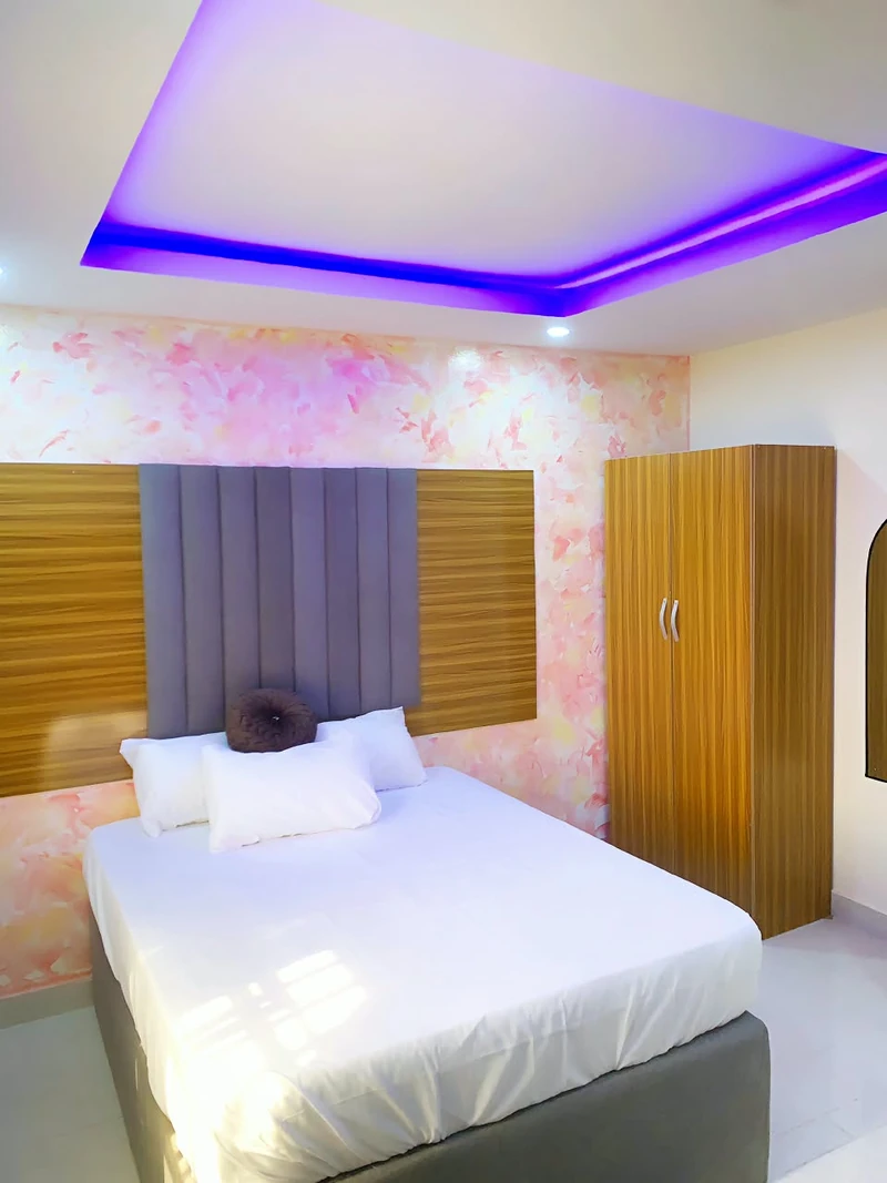 Hotel room with wardrobe and ambient lighting