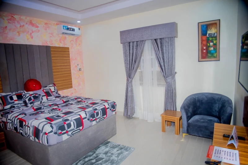 Hotel room with patterned duvet and armchair