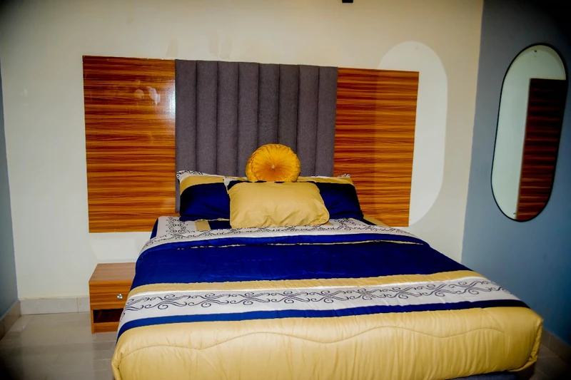 Hotel room dressed in royal blue and gold bedding
